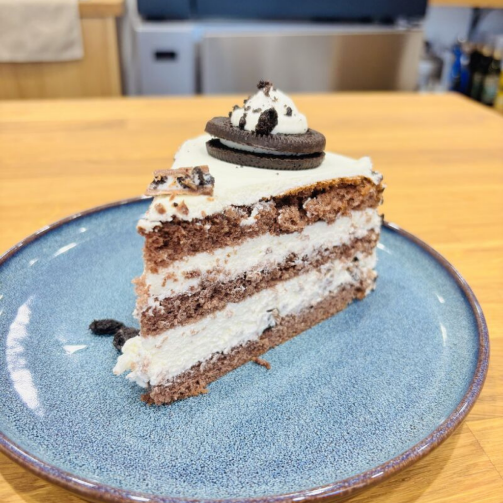 Slice of Oreo cake showing alternating sponge and cream layers