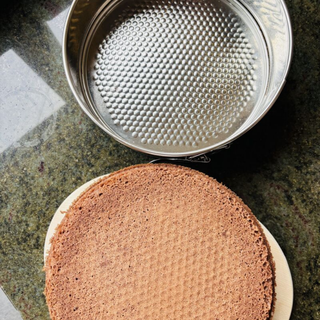 Chocolate Vienna sponge turned out of a springform tin with a clean, even crust